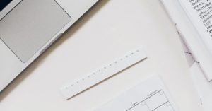 close up of paper and a laptop on a desk
