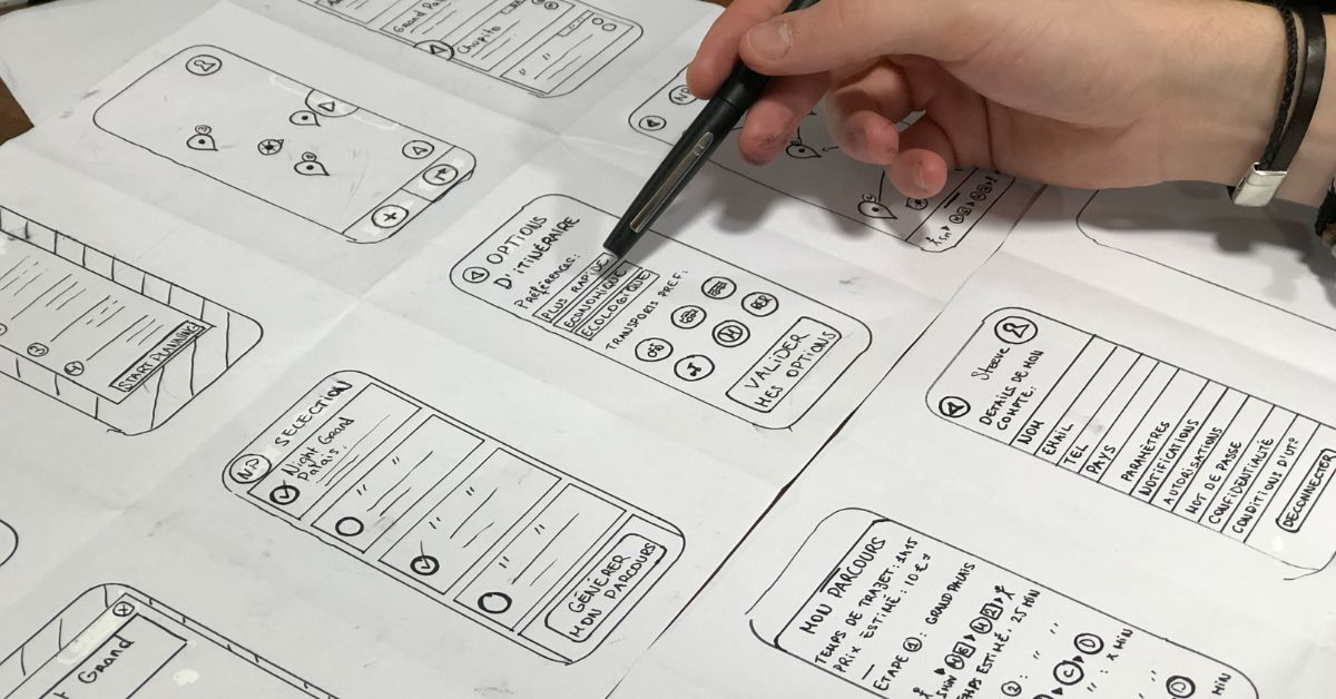 person drawing out a design interface